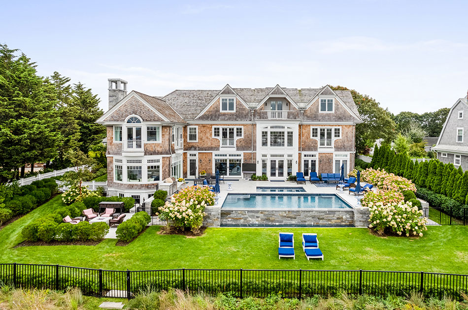 Rear exterior of large home with pool